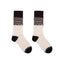 Pair of socks with a patterned cuff on a white background