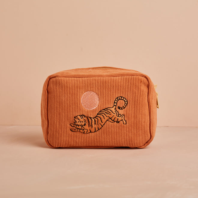 dusty orange makeup bag with tiger and sun embroidery 