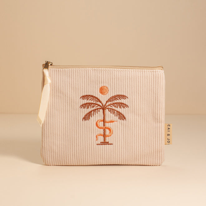 stone pouch with embroidered palm tree with sun and snake 