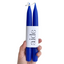 Two blue candles in a holder with 'aide' branding on a white background