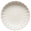 Round ceramic plate with textured surface on a white background