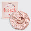 Pink satin-lined hair bonnet with cherry pattern and 'kit-sch' packaging on a light gray background