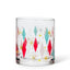Clear glass tumbler with colorful geometric pattern on a white background