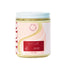 Scented candle jar with a decorative label on a white background