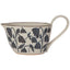 Ceramic gravy boat with floral pattern on a white background