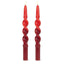 Two red twisted candles on a white background