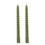 Two green twisted candles on a white background