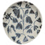 Round ceramic spoon rest with blue floral pattern on a white background