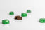 Green and chocolate candies on a white background