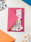 Pink envelope with a cat illustration on a colorful background