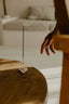Incense stick with smoke on a wooden surface, blurred background