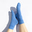 Blue socks worn on a white background