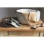 Dishes and utensils on a wooden surface with folded cloths.