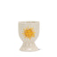 White ceramic egg cup with a yellow sun design on a white background