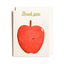 A square greeting card with a white envelope behind it, featuring a cute red apple illustration and the words 'Thank you' in green at the top.