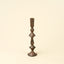 Bronze candlestick on a beige background