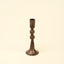 Bronze candle holder on a beige background