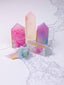 Colorful crystal-like objects on a white marble surface