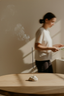 Person using incense on a wooden table with a blurred background