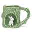 Green ceramic mug shaped like a tree with a rabbit inside on a white background