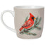 A white ceramic mug with a light beige exterior, decorated with a painted red cardinal perched on a green pine branch.