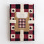 Tea towel with checkered pattern and card suit symbols on a white background
