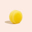 Yellow ball on a beige background
