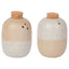 Two ceramic jars with cork lids on a white background