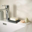 Soap dish with soap bars and a sponge on a kitchen sink