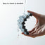 Hand holding a clear silicone product with water splashes, labeled 'Easy to clean & durable'.