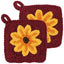 Two red crocheted pot holders with yellow flower designs on a white background