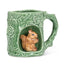 Green ceramic mug shaped like a tree with a squirrel figure inside on a white background