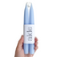 Hand holding two blue candles in a white holder with 'aide' branding on a white background