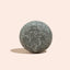 Gray stone sphere on a beige background
