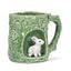 Green ceramic mug with rabbit design on a white background