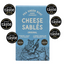 A boxed food product labeled 'PEA GREEN BOAT BAKERY CHEESE SABLÉS ORIGINAL' on a light blue package, surrounded by multiple circular 'great taste' award badges on a white background.