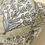 Close-up of a quilted fabric with floral pattern on a beige background