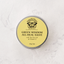 A round silver tin of Butterfly Weed Green Wisdom All-Heal Salve, featuring a pale yellow label with black text and a butterfly logo, set against a light gray marble background.