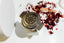 Tea infuser with 'Brew & Infuse' branding on a white surface with dried flowers.
