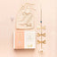 Gold suncatcher with packaging and drawstring bag on a beige background
