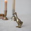 Bronze duck-shaped bell on a light background