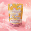 A stand-up pouch of Bubble Potion Unicorn Magic bubble bath powder, featuring a yellow and pink design with cartoon unicorns, set against a pink background with floating bubbles.