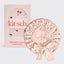 Pink satin bonnet with cherry pattern next to its packaging box on a light gray background