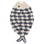 Crocheted fish-shaped blanket with navy and white pattern on a white background