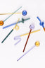 Colorful glass straws on a white background