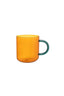 Orange mug with a green handle on a white background