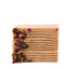 Bar of soap with dried flowers on a white background