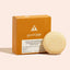 Good Juju shampoo bar and packaging on a beige background