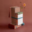 Stack of books with decorative ribbons and a tassel on a brown background