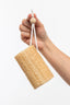 Hand holding a natural sponge with a white background